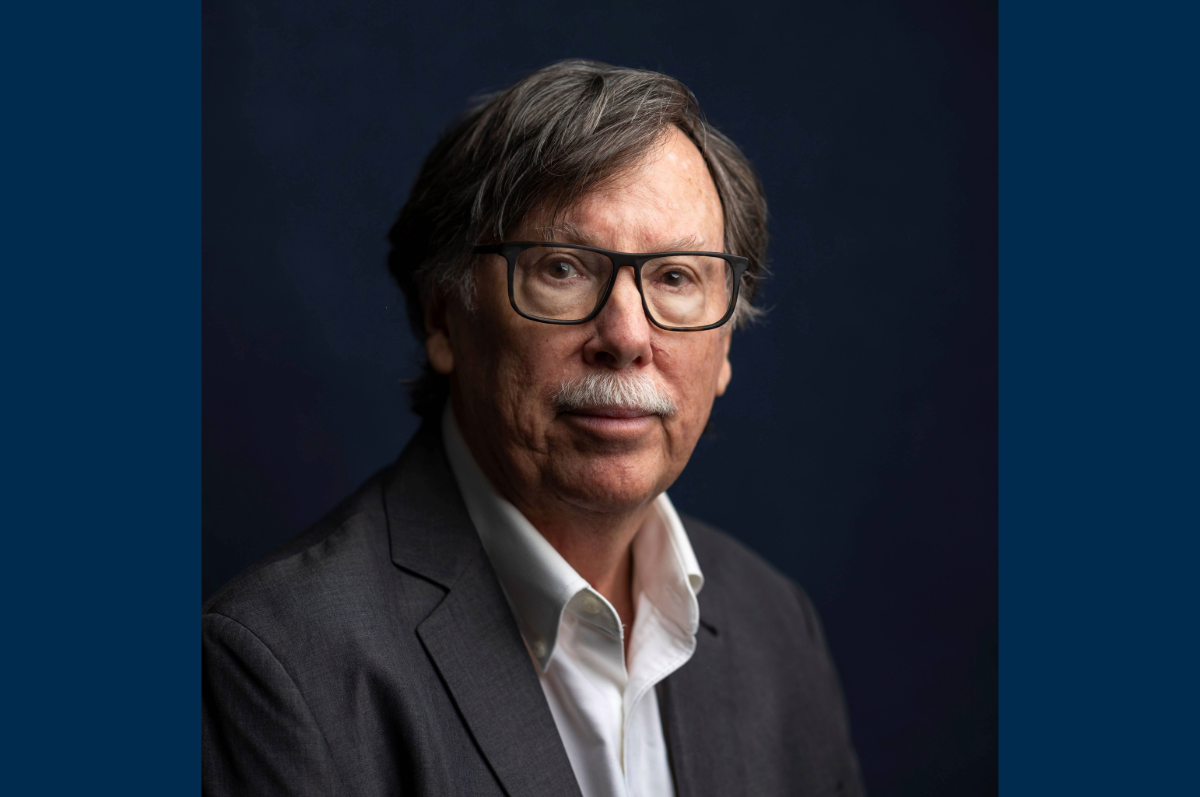 Portrait of man with glasses against dark background
